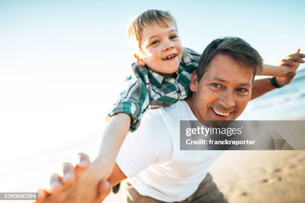 happy father embracing the son - child on mans shoulder stock pictures, royalty-free photos & images