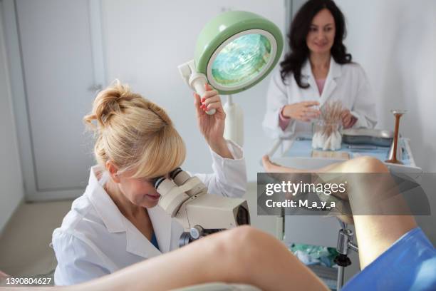gynaecologist examining a patient - gynecological chair stock pictures, royalty-free photos & images