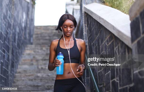 A Young African woman exercising outdoors.