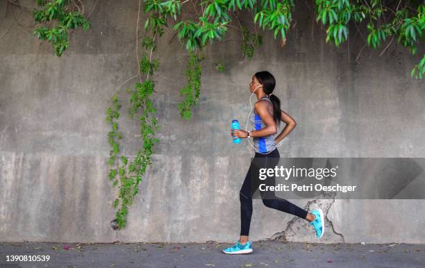 A Young African woman exercising outdoors.