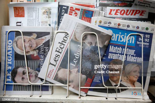 The front pages of the French newspapers, Le Figaro, Les Echos and Le Parisien are displayed in a newsstand with the photos of Emmanuel Macron and...