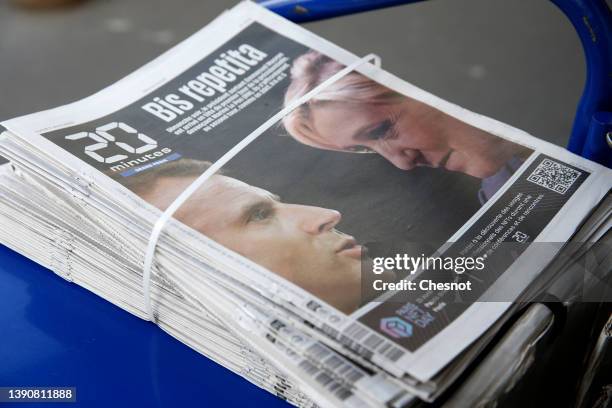 The front page of the French newspaper, 20 Minutes is displayed in a newsstand with the photos of Emmanuel Macron and Marine Le Pen the day after the...