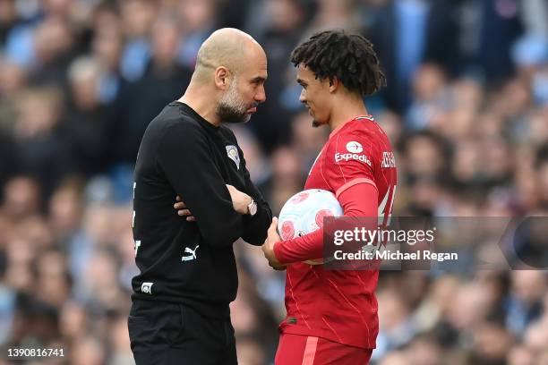 Manchester City manager Pep Guardiola shares a joke with Trent Alexander-Arnold of Liverpool during the Premier League match between Manchester City...