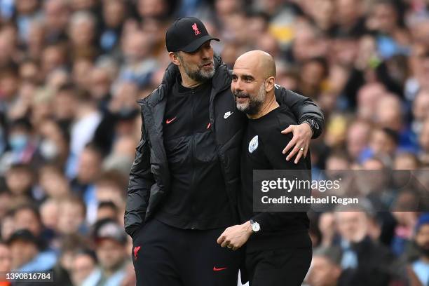 Manchester City manager Pep Guardiola shares a joke with Liverpool manager Jurgen Klopp during the Premier League match between Manchester City and...