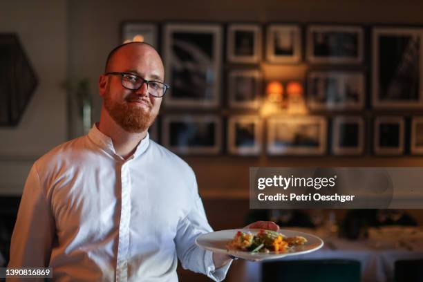 The head chef at a gourmet restaurant preparing for dinner service.