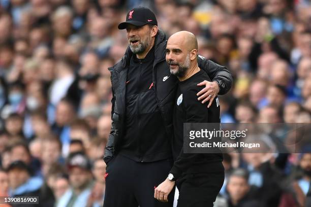 Manchester City manager Pep Guardiola shares a joke with Liverpool manager Jurgen Klopp during the Premier League match between Manchester City and...