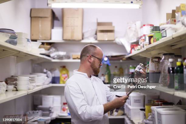The head chef at a gourmet restaurant takes stock before dinner service.