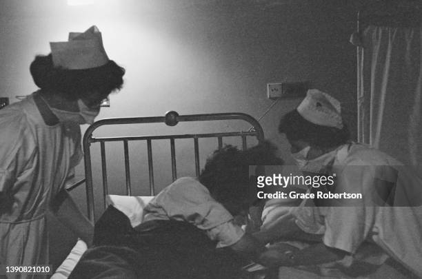 Two midwives helping a pregnant woman during labor at a birth centre, UK, 1956. Original Publication: Picture Post - 9111 - Analgesia - unpub.