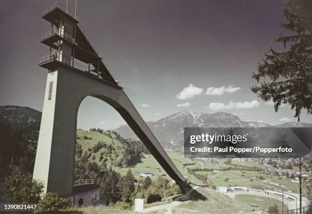 The Grosse Olympiaschanze ski jumping hill above the town of Garmisch-Partenkirchen alpine town in the state of Bavaria in West Germany circa 1965....