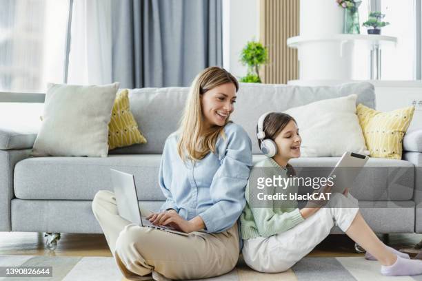 alegre madre e hija usando tecnología inalámbrica - teen computer fotografías e imágenes de stock