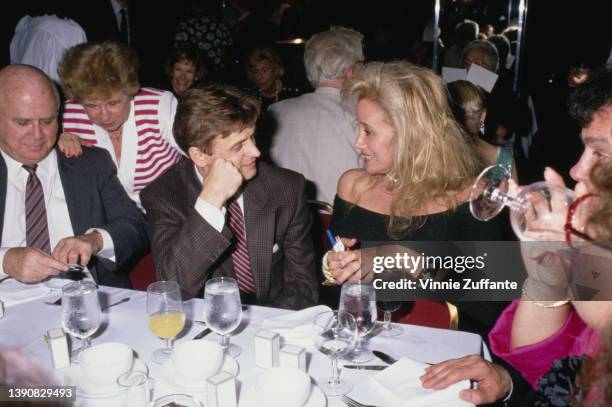 Soviet-born Latvian-America dancer, choreographer and actor Mikhail Baryshnikov, wearing a glen-check suit with a striped tie, in conversation with...