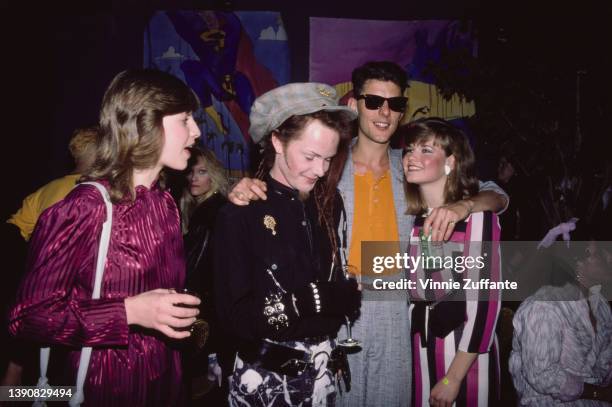 British guitarist and singer Gary McDowell and British singer Robbie Grey, both of British New Wave band Modern English, with two women, circa 1985.