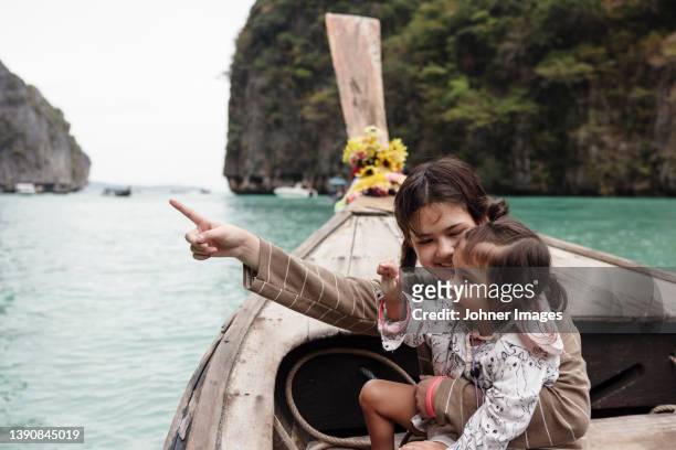 mother and daughter sitting in traditional boat in canyon - thailand vacation stock pictures, royalty-free photos & images