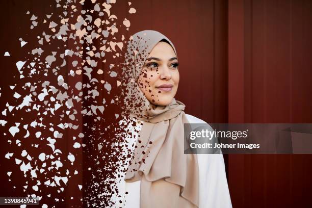 young woman in headscarf falling into pieces - biometrics stock pictures, royalty-free photos & images