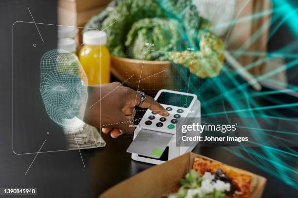 woman paying for food with payment card - facial recognition technology stock-fotos und bilder