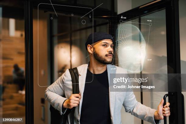 young businessman leaving office building - facial recognition technology stock-fotos und bilder