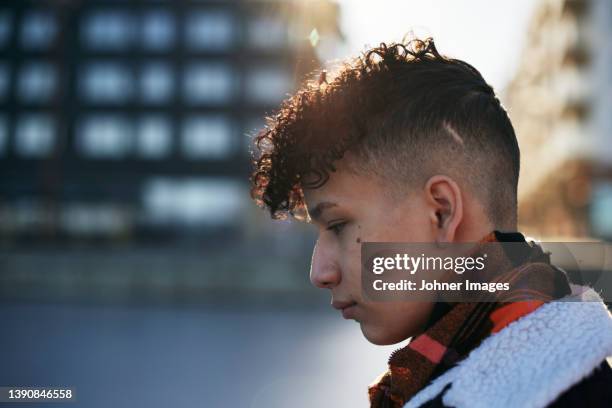 teenage boy looking away - curly man stock pictures, royalty-free photos & images