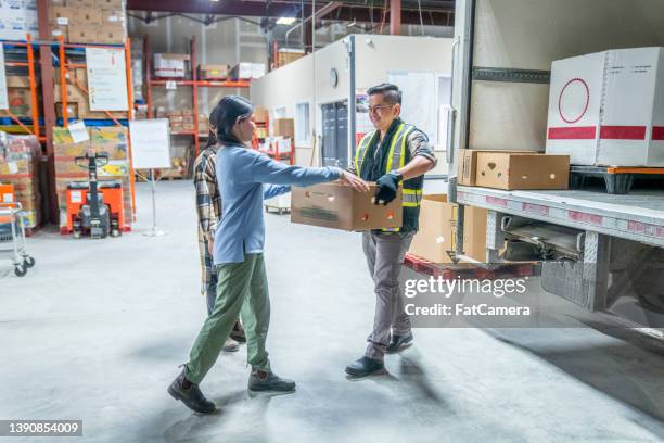 unloading the truck - unloading stockfoto's en -beelden