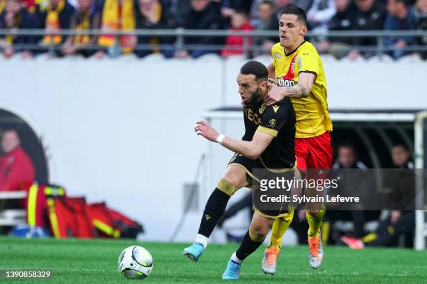 Amine Gouiri of OGC Nice is challenged by Florian Sotoca of RC Lens during the Ligue 1 Uber Eats match between RC Lens and OGC Nice at Stade...