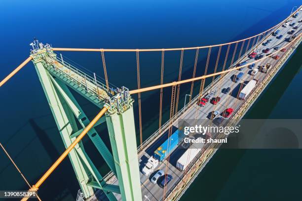 heavy traffic crossing suspension bridge - truck birds eye stock pictures, royalty-free photos & images