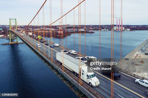 semi truck crossing bridge - north america aerial stock pictures, royalty-free photos & images