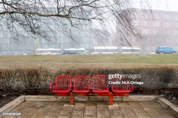 an afternoon of unsettled weather in spring - bus bench stock pictures, royalty-free photos & images