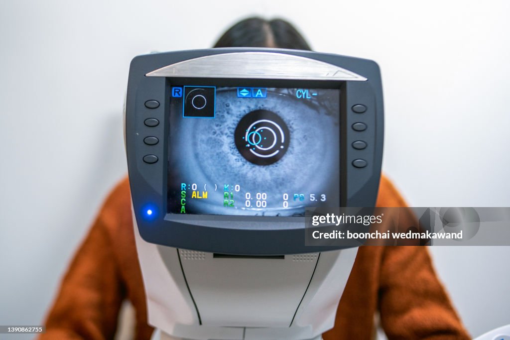 A Women having an eye exam at ophthalmologist's office.