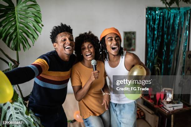 friends singing together at home - black people party stock pictures, royalty-free photos & images