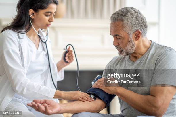 blood pressure check at home - screening stockfoto's en -beelden