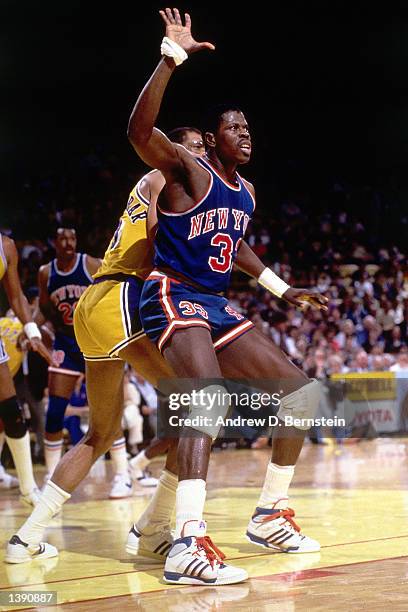 Patrick Ewing of the New York Knicks battles for position against Kareem Abdul Jabbar of the Los Angeles Lakers during an NBA game at The Forum in...