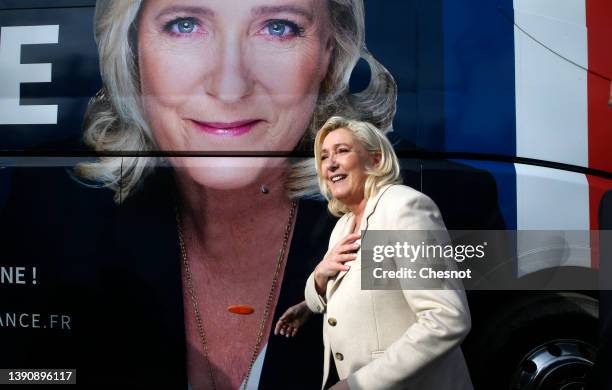 France's far-right party ‘Rassemblement National’ leader, Marine Le Pen candidate for the 2022 presidential election walks pas her portrait drawn on...