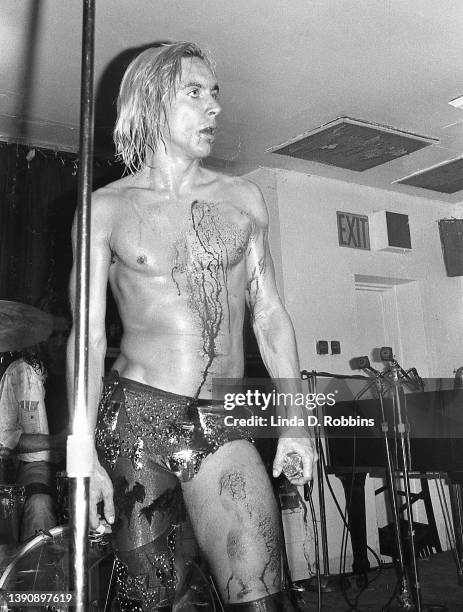 Iggy Pop performing onstage with the Stooges at Max's Kansas City after cutting his bare chest falling on a table, New York, 31st July 1973.