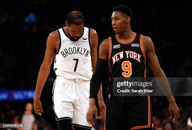 Kevin Durant of the Brooklyn Nets and RJ Barrett of the New York Knicks look on during the first half at Madison Square Garden on April 06, 2022 in...