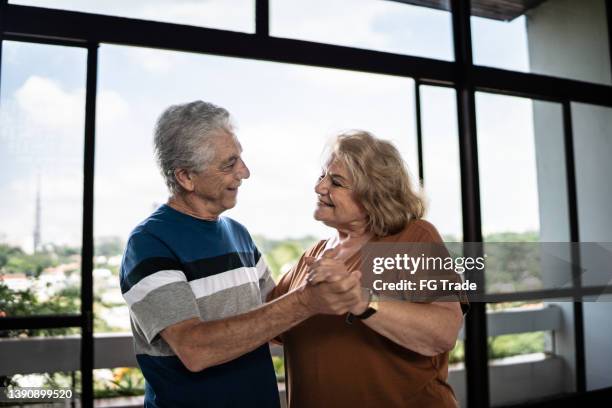 happy senior couple dancing at home - free pictures ballroom dancing stock pictures, royalty-free photos & images