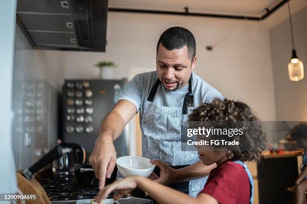 father and son cooking together at home - fathers day lunch stock pictures, royalty-free photos & images