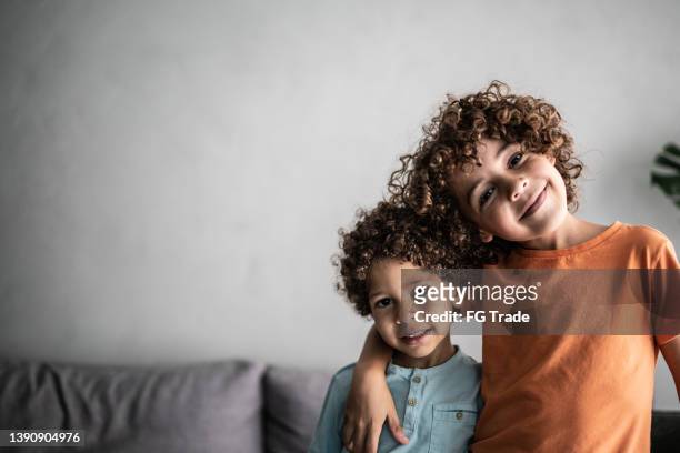 portrait of two brothers at home - sibling stock pictures, royalty-free photos & images