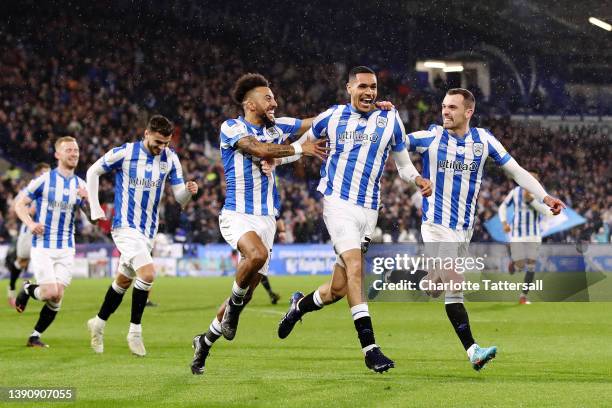 Jon Russell of Huddersfield Town celebrates with team mates Sorba Thomas and Harry Toffolo after scoring their sides first goal during the Sky Bet...