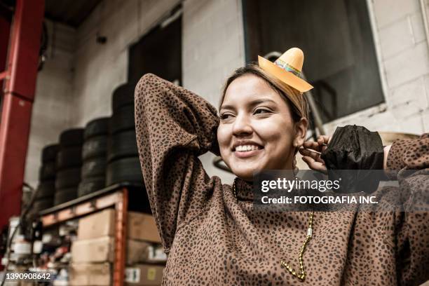 latin woman with party sombrero at the fiesta party - cheesy grin stock pictures, royalty-free photos & images