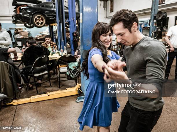 latin couple dancing at the fiesta birthday party - line dancing stock pictures, royalty-free photos & images