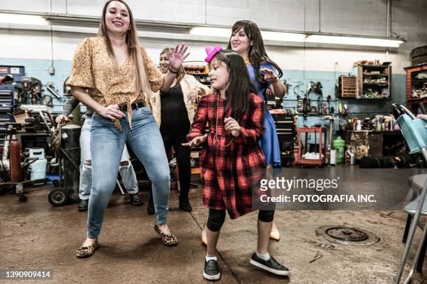 latin women and girl dancing at the fiesta birthday party - line dancing stock pictures, royalty-free photos & images