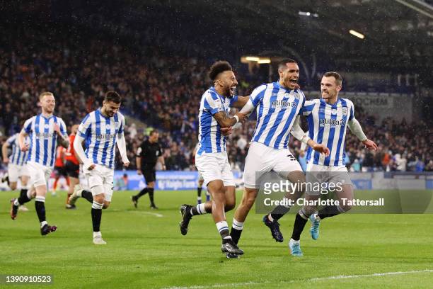 Jon Russell of Huddersfield Town celebrates with team mates Sorba Thomas and Harry Toffolo after scoring their sides first goal during the Sky Bet...