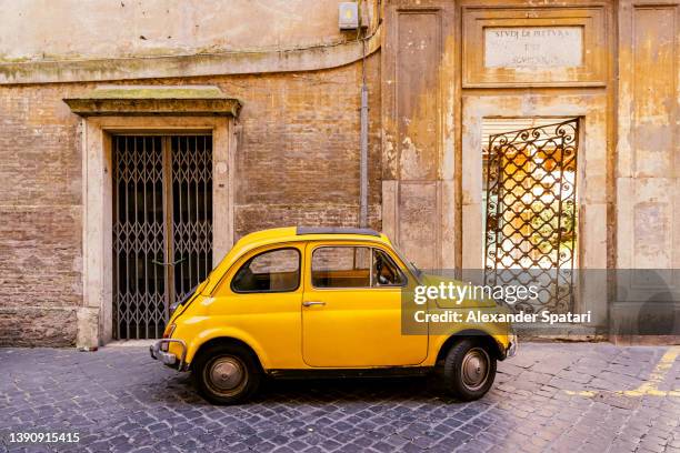 small yellow car on the street in rome, italy - old rome fotografías e imágenes de stock