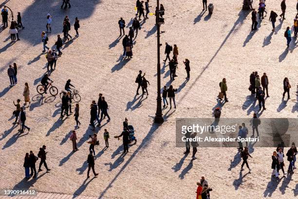 people walking on the city square at sunset, aerial view - crowd of people walking stock pictures, royalty-free photos & images