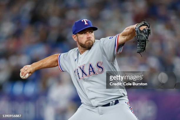 Greg Holland of the Texas Rangers pitches in the eighth inning of their MLB game against the Toronto Blue Jays on Opening Day at Rogers Centre on...