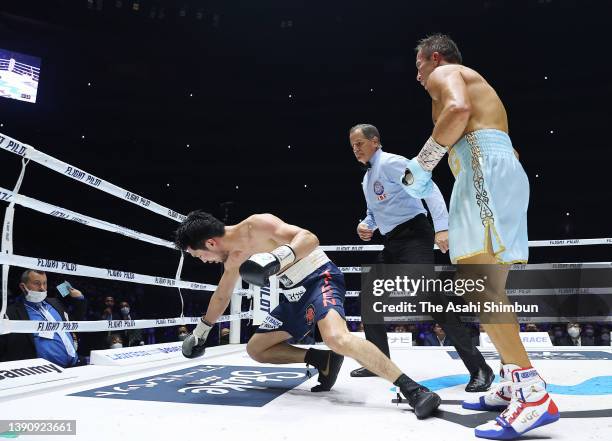 Gennadiy Golovkin of Kazakhstan knocks down Ryota Murata of Japan in the 9th round during the IBF & WBA Middleweight title bout at Saitama Super...