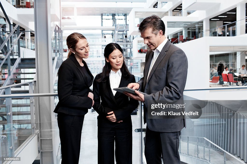 Business people looking at tablet computer