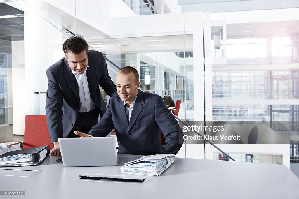 Businessmen looking at laptop