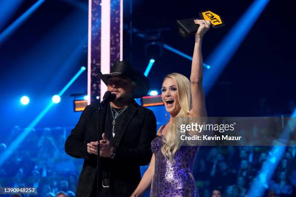 Jason Aldean and Carrie Underwood accept an award for Collaborative Video of the Year onstage at the 2022 CMT Music Awards at Nashville Municipal...