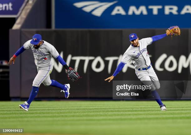 Teoscar Hernandez and Lourdes Gurriel Jr. #13 of the Toronto Blue Jays celebrate the win over the New York Yankees at Yankee Stadium on April 11,...