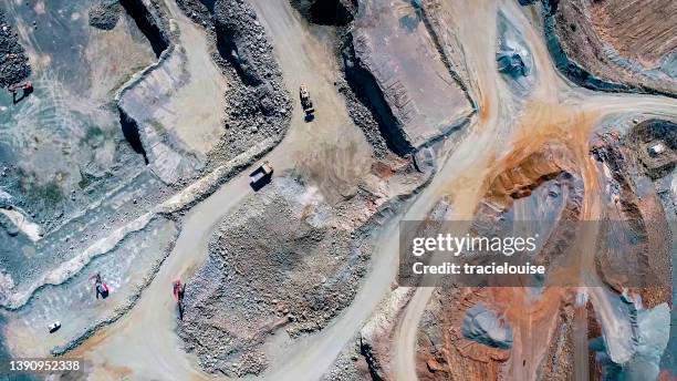 aerial footage of a gravel quarry - mijnindustrie stockfoto's en -beelden